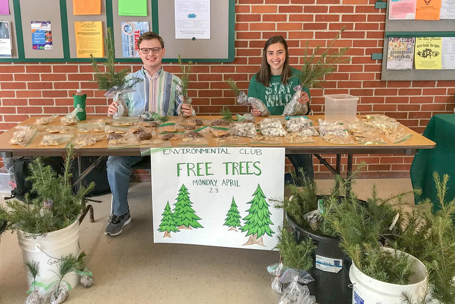Students giving away tree seedlings on Earth Day