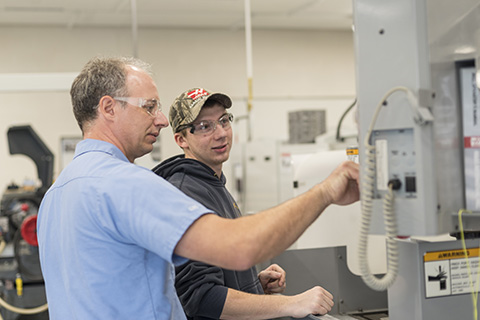 Terry Morse working with a student in Delta's CNC lab