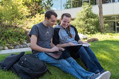 Students on laptop in Courtyard