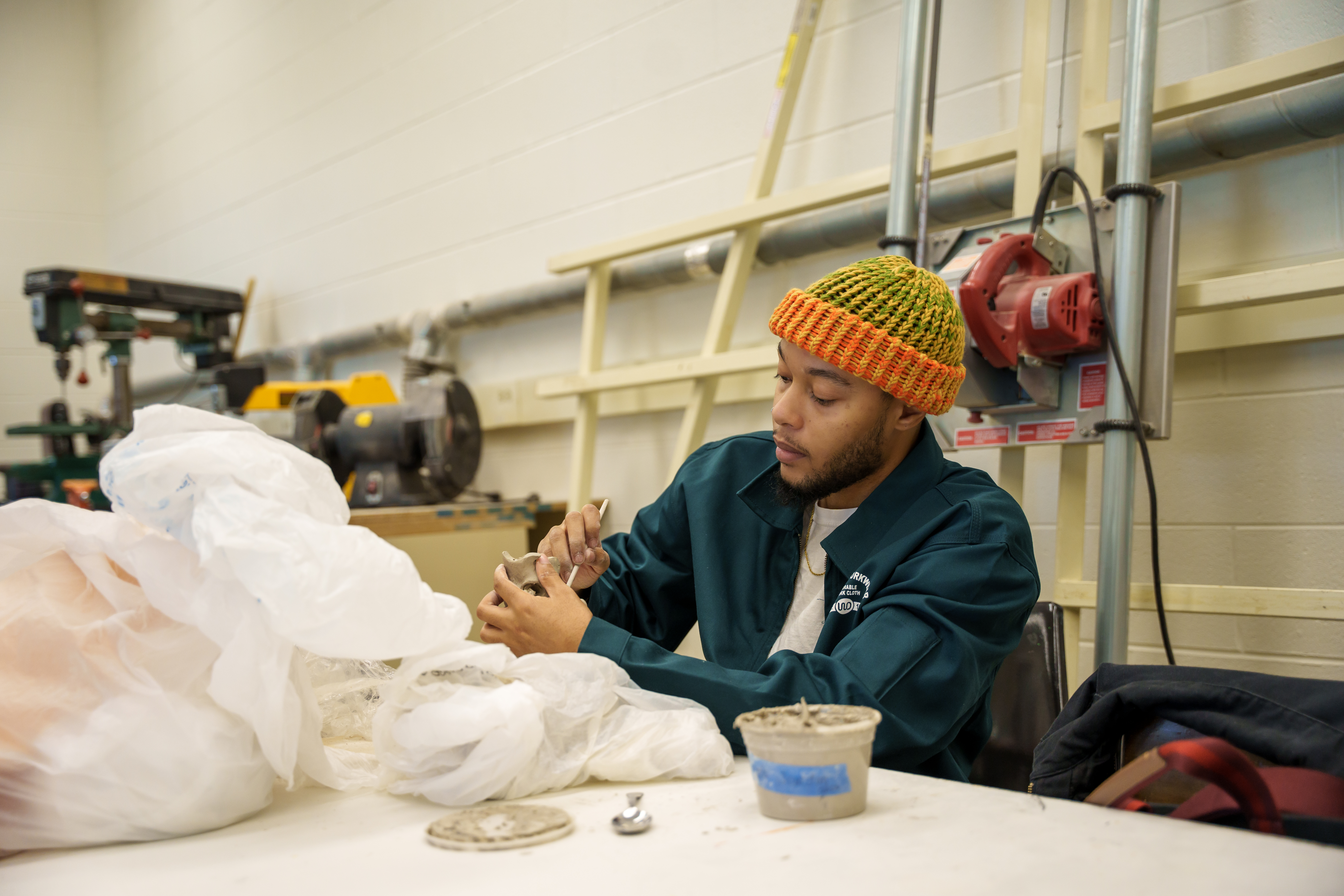 Delta College ceramics student holding clay