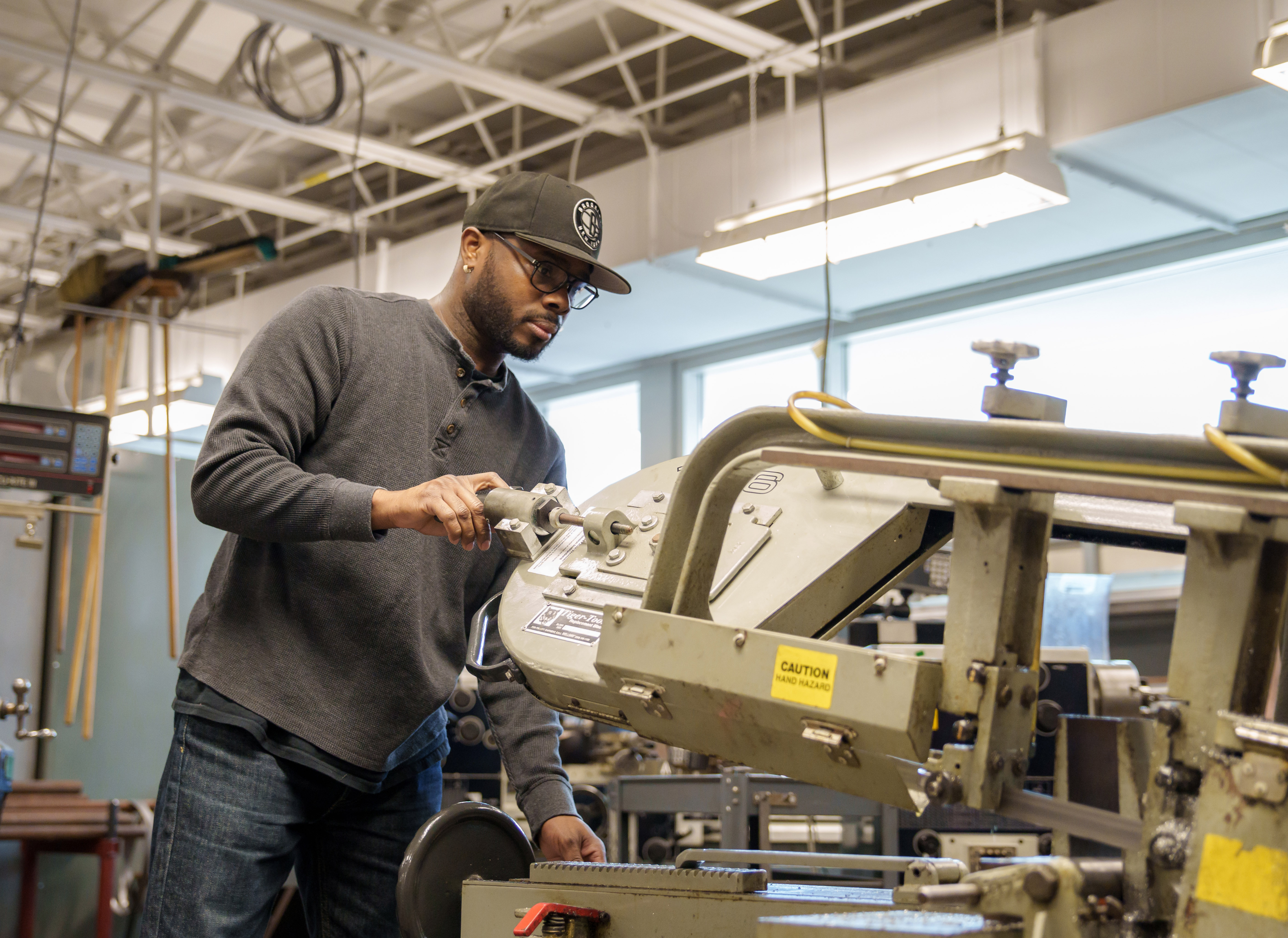 Delta College computer numerical control student using equipment in CNC lab