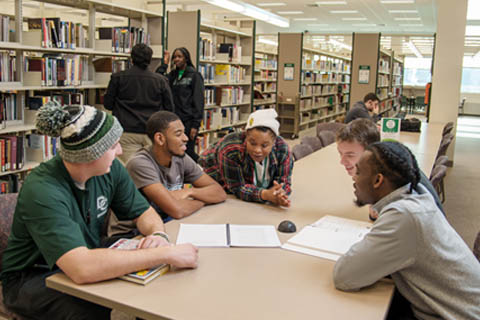 Delta College students sitting around a table in the library