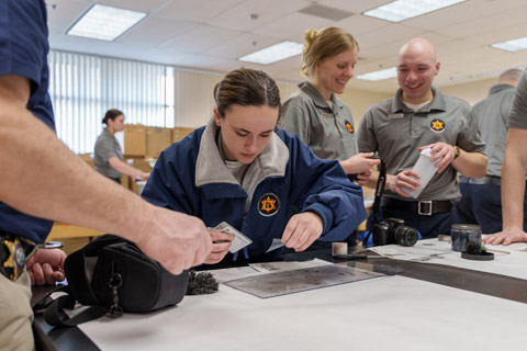 Delta College police academy students dusting for fingerprints