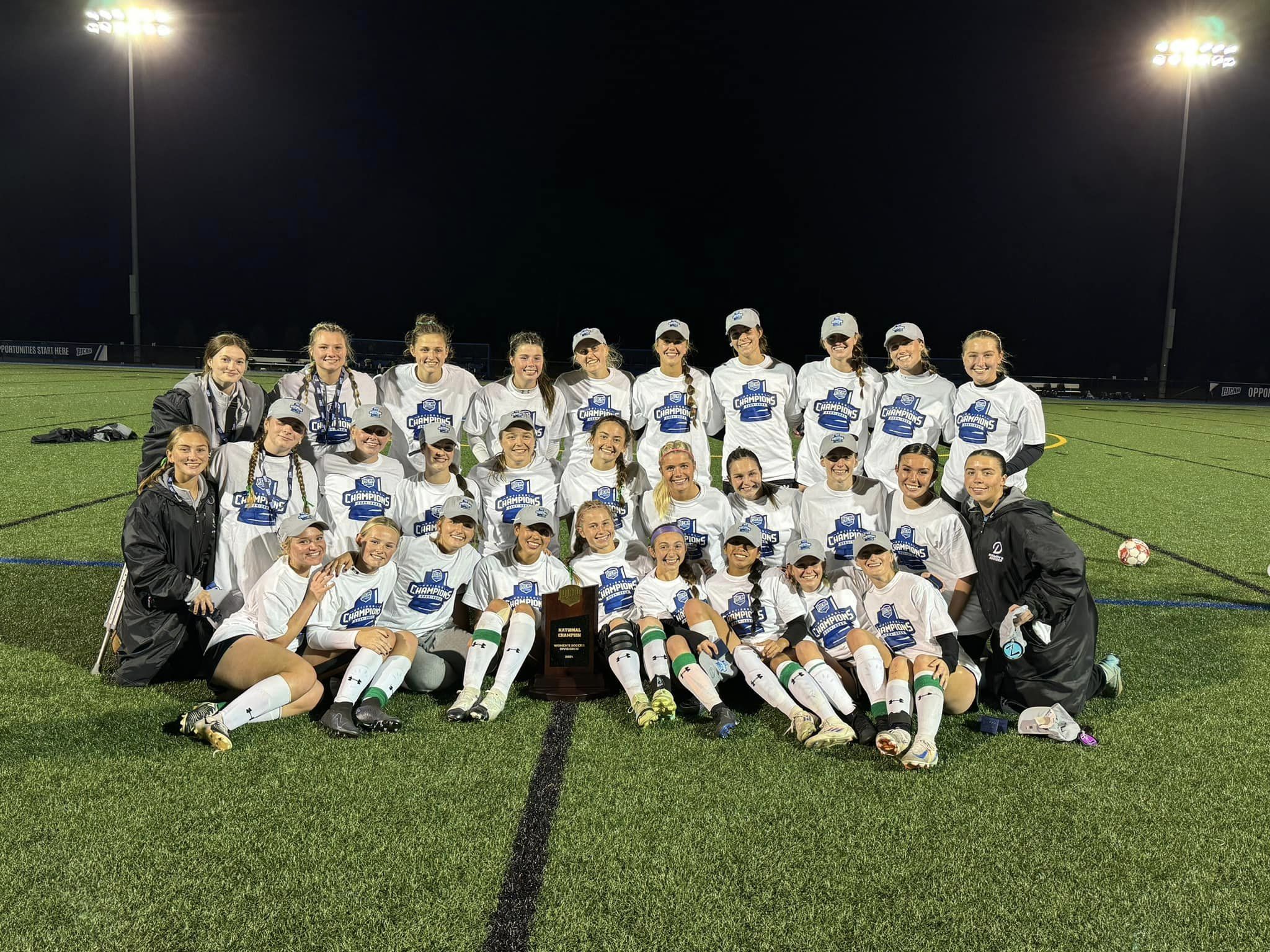 2024 Delta College women's soccer team poses for a group photo with their national championship trophy