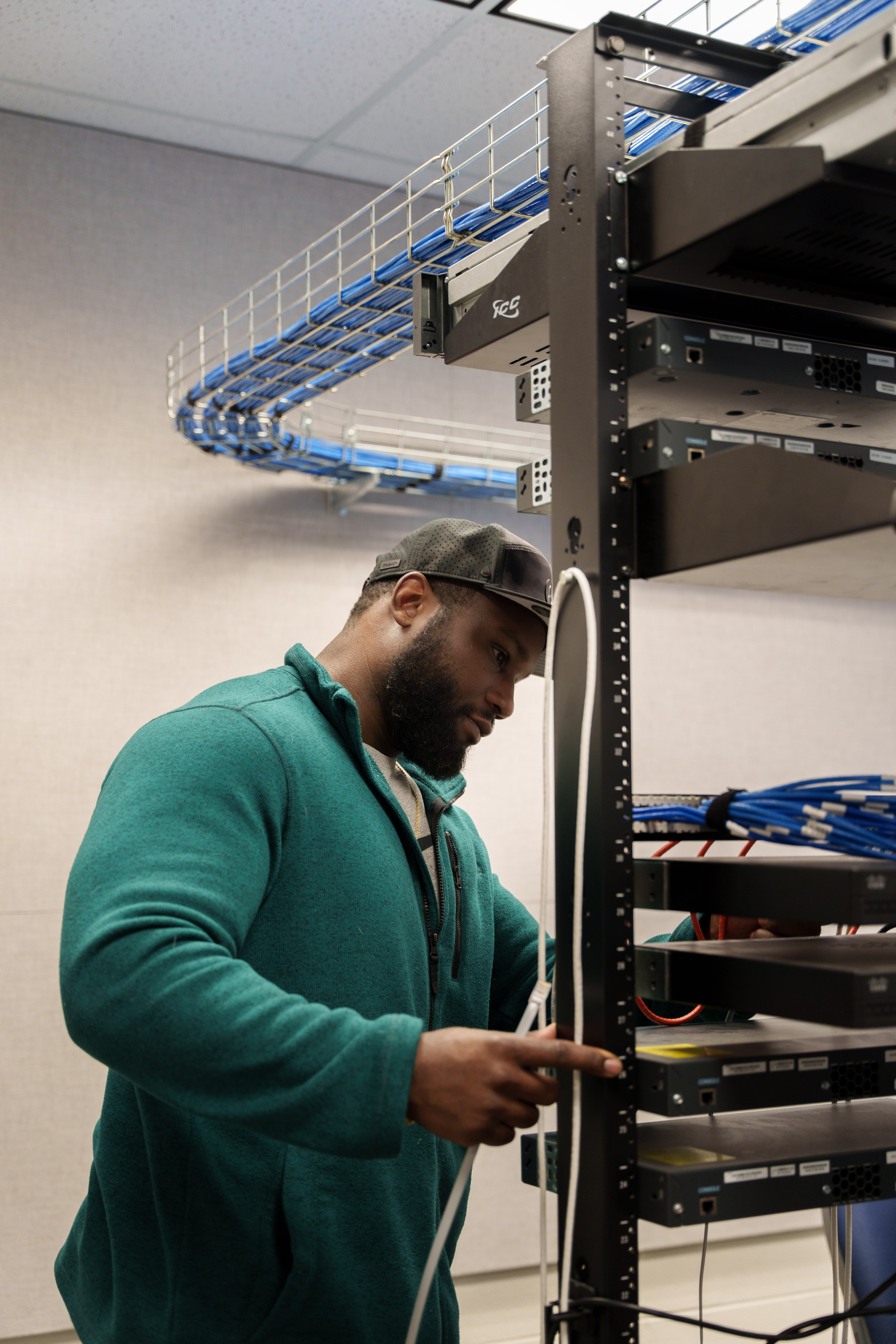 Network administration student holding cables at Delta College