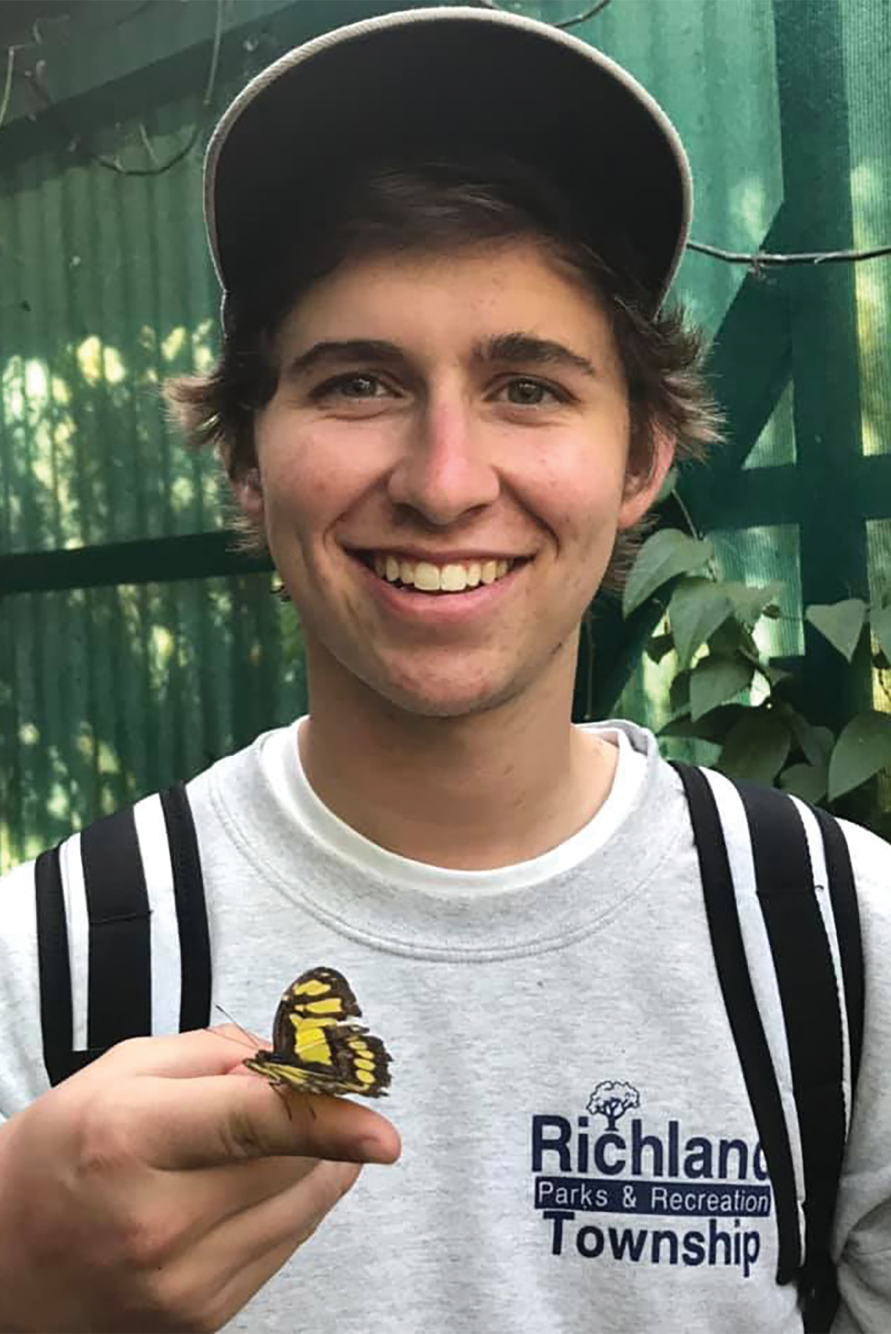 Student holding butterfly in Costa Rica