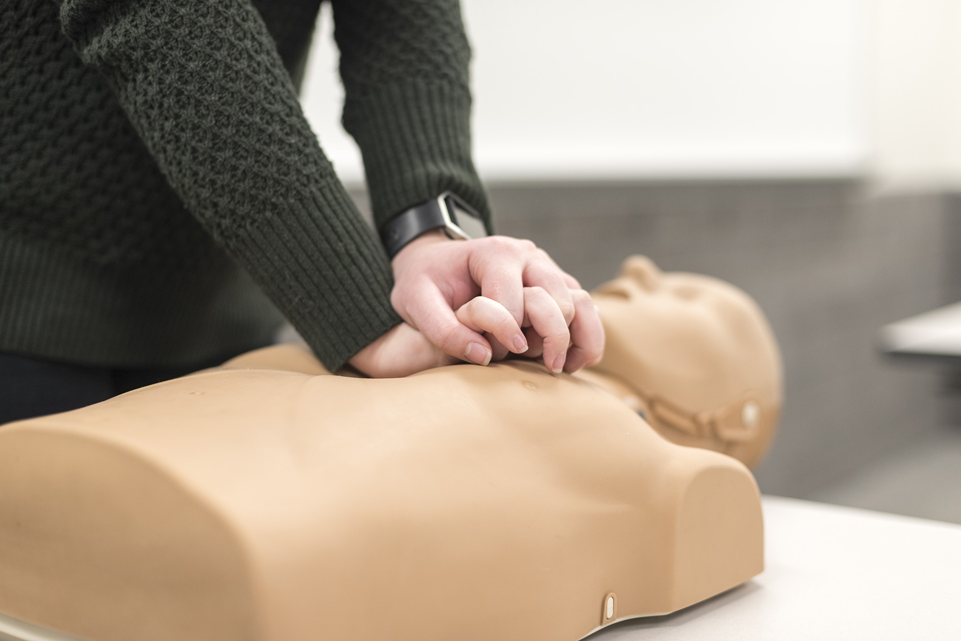 Student practicing on adult CPR manikin